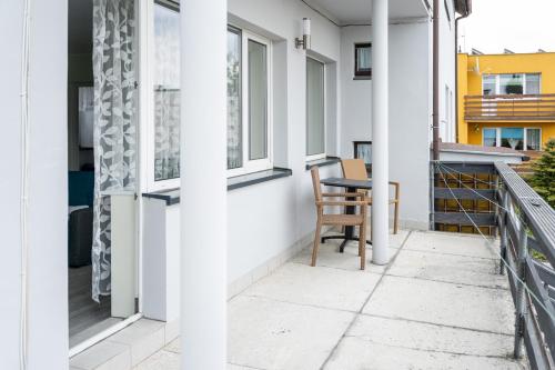 a balcony with a table and a chair at Marinas Rewa in Rewa