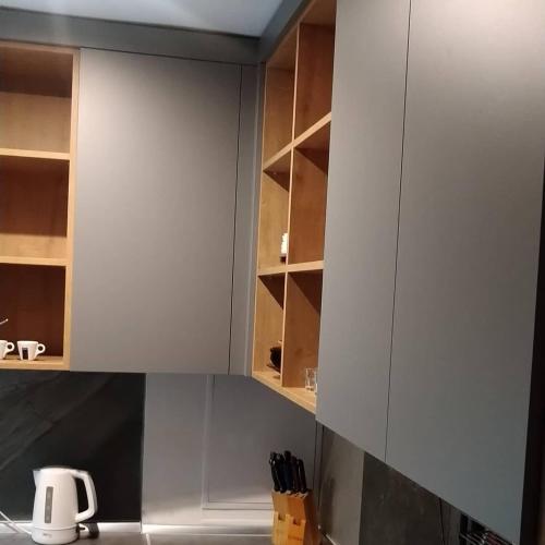 a kitchen with white cabinets and a kitchen sink at Guest House Dacha in Karolino-Buhaz