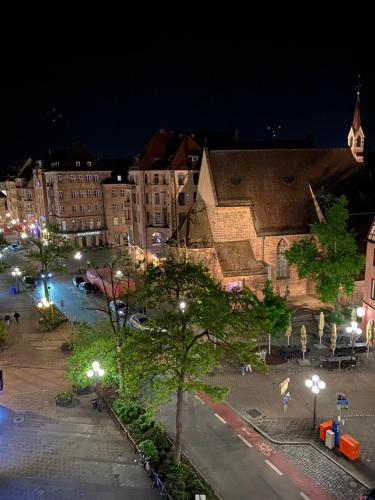 a city street at night with buildings and street lights at Hotel Deutscher Kaiser in Nürnberg