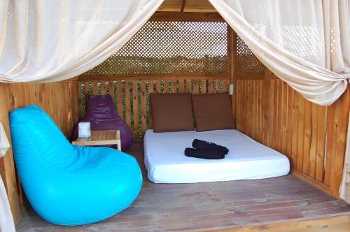 a bed and a chair in a room at Grand Koru Hotel Beach in Yalova