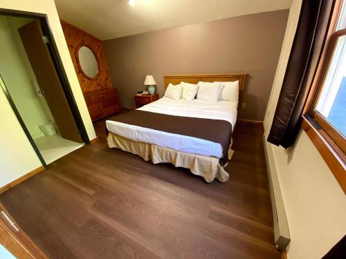 a hotel room with a bed and a window at Woodland Inn & Suites in Medford