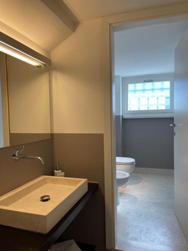 a bathroom with a sink and a toilet at Morin Forte dei Marmi in Forte dei Marmi