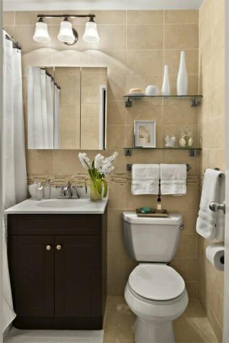 a bathroom with a toilet and a sink and a mirror at Divijuka in Taganga
