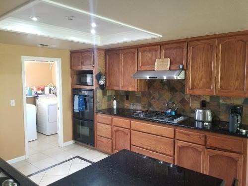 a kitchen with wooden cabinets and black counter tops at St. Anna's House in Squaw Valley