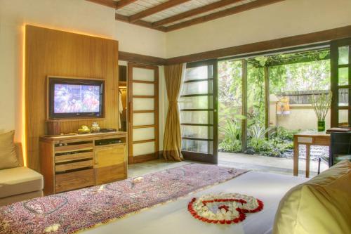A television and/or entertainment center at Komaneka at Monkey Forest Ubud
