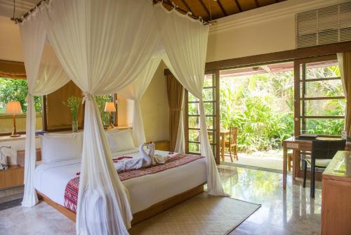 Кровать или кровати в номере Komaneka at Monkey Forest Ubud