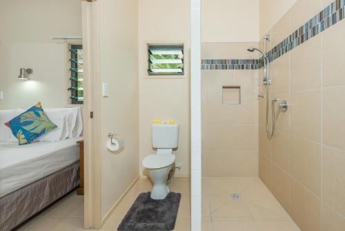 a bathroom with a toilet and a shower at Cook Islands Holiday Villas - Turangi Lagoon in Muri