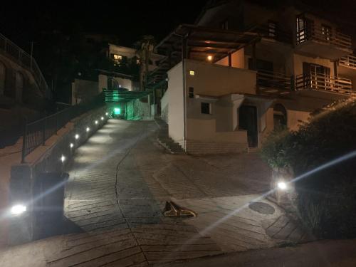an empty street at night with a green light at Apartments Opatija Sea View in Opatija
