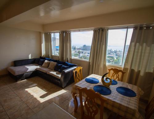 a living room with a couch and a table at 3 Dolphins in Rosarito