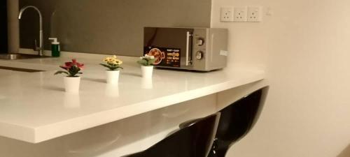 a kitchen counter with a microwave on top of it at Cozy Studio unit,Cyberjaya,Wifi, Netflix,Free parking in Cyberjaya