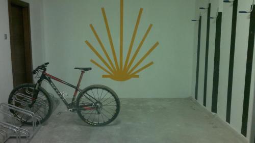 a bike parked in a room with a sun on the wall at F&G Logroño in Logroño