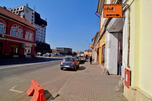 a car is parked on the side of a street at Apartament 12 Central in Târgu-Mureş