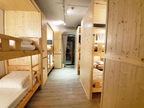 a hallway with several bunk beds in a room at On My Way Taitung Hostel in Taitung City