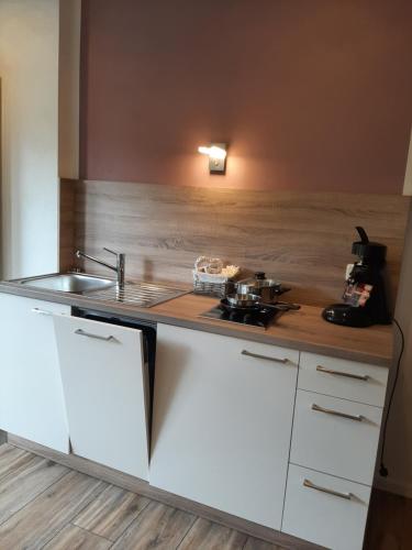 a kitchen with a sink and a counter top at Fewo Zum Sonnenschein in Simmerath