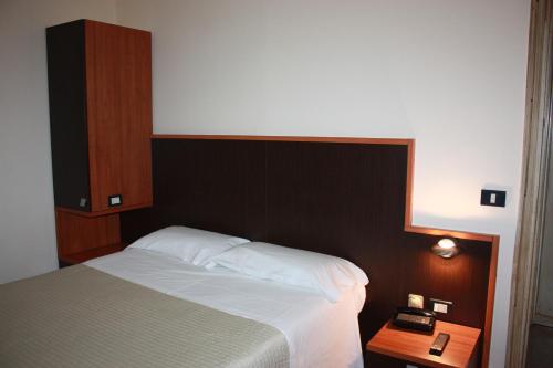 a bedroom with a bed with a black head board at Monti Azzurri in Montemonaco