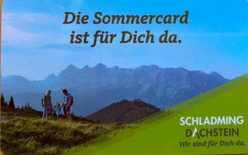 a poster of two people walking on a mountain at Landhaus Birgbichler - Apartments in Ramsau am Dachstein - inklusive SOMMERCARD! in Ramsau am Dachstein