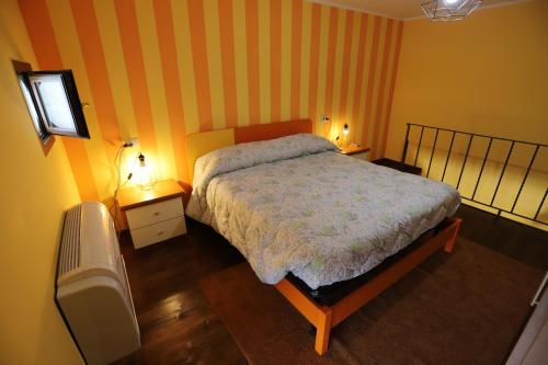 a bedroom with a bed and two night stands with lamps at Casa Patrizia in Capodimonte
