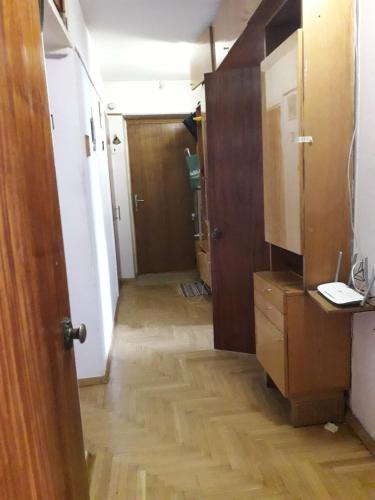 a hallway of a room with a wooden floor at apartment Galitskaya Square in Kyiv