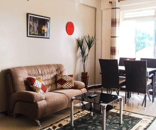 a living room with a couch and a table at Karibu BB Suites in Entebbe