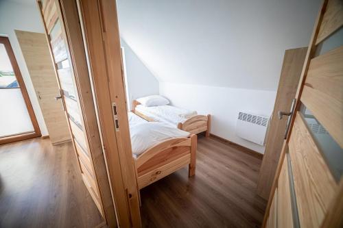 Posteľ alebo postele v izbe v ubytovaní Prowincja Tatra Cottages
