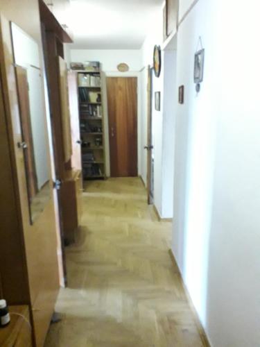 a hallway with a long floor with a room with white walls at apartmtnt near Victori Squaue in Kyiv