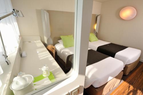 a small room with two beds and a sink at Campanile Toulouse Sud-Labège innopole in Labège