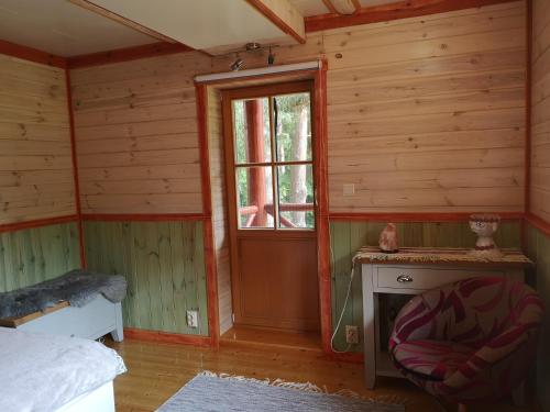 a room with a bed and a window and a fireplace at Villa Georgia in Aardla