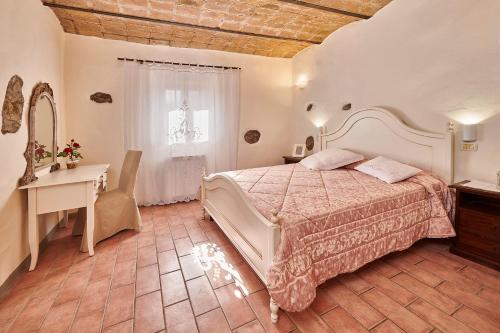 a bedroom with a bed and a table and a desk at La Rosa in Città di Castello