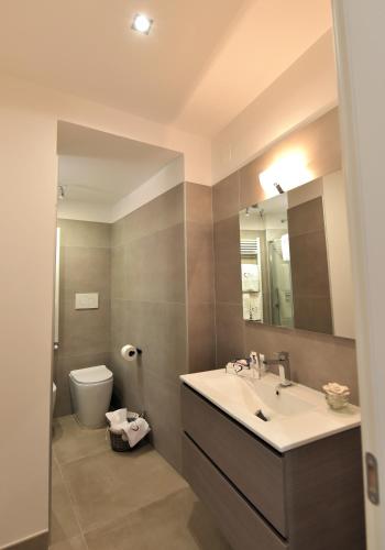 a bathroom with a sink and a toilet and a mirror at Love inn in Pompei