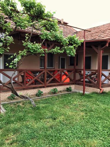 a house with a wooden fence and a yard at Villa “Eleon” in Velyka Bihanʼ