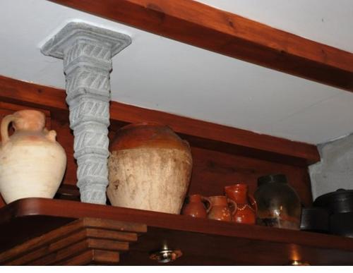 a shelf with vases and a cross on it at Caseta Sorripas in Bielsa