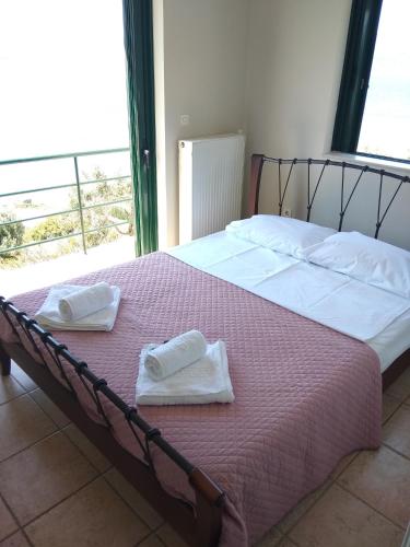 a bedroom with two beds with towels on them at Marmari megali ammos oasis studio's in Ayía Marína