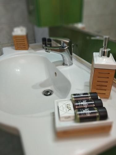 a bathroom sink with a toothbrush and a toothbrush holder at Marmari megali ammos oasis studio's in Ayía Marína