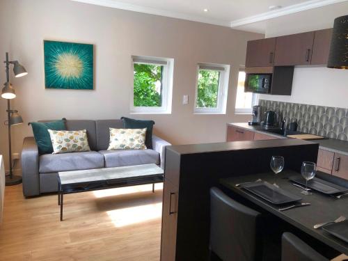 a kitchen and living room with a couch and a table at la maison du philosophe in Amboise