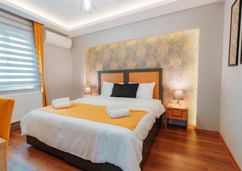 a bedroom with a large bed with two pillows at Umut Apartments in Trabzon
