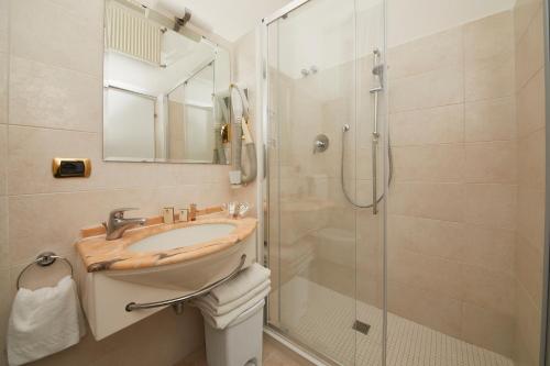 a bathroom with a sink and a shower at Hotel Vienna Ostenda e Ristorante il Danubio in Rimini
