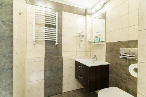a bathroom with a toilet and a sink at Astra Apartments in Oświęcim