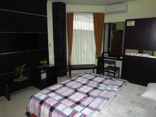 Ένα ή περισσότερα κρεβάτια σε δωμάτιο στο Enny's Guest House