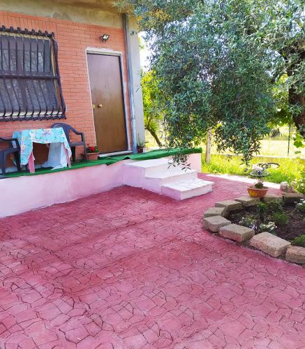 a house with a red brick patio with a door at B&B Villa Sabrina in Sonnino