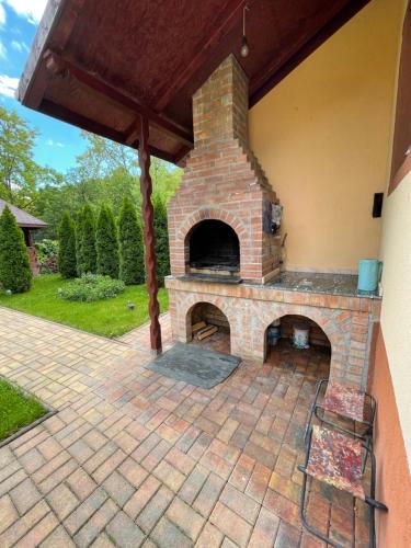 a brick oven in a patio with a roof at Natura Magura in Buzau
