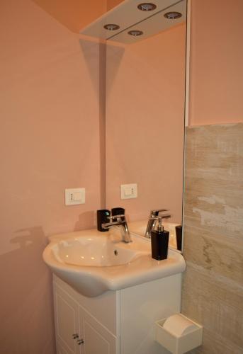 a bathroom with a sink and a mirror at tra il borgo e il mare in Cervo