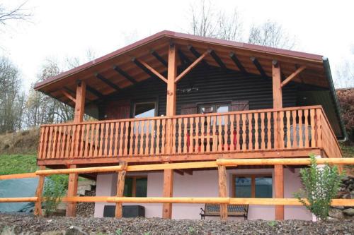 a large log cabin with a large deck at Le Chalet du bonheur , individuel avec belle vue in Laveline