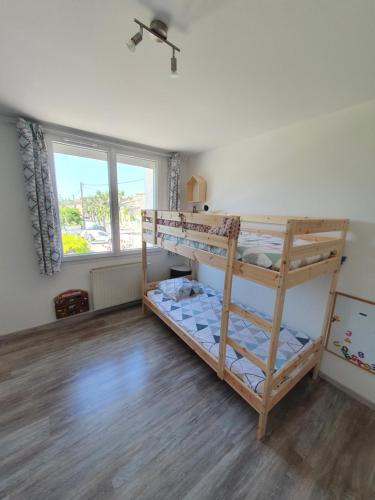 - une chambre avec 2 lits superposés et une fenêtre dans l'établissement Le petit provencal, à Espeluche