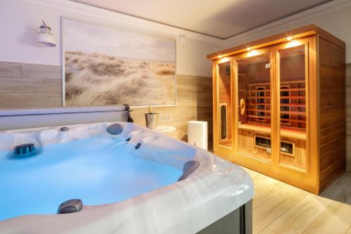 a large bathroom with a tub and a wine cellar at Villa Baltic Sand in Międzyzdroje
