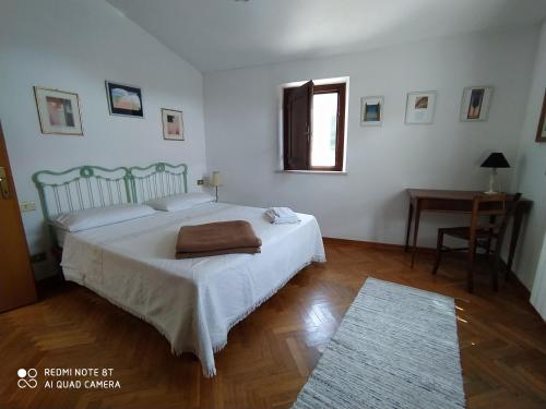 a bedroom with a large bed and a table at Vignano40 in Siena