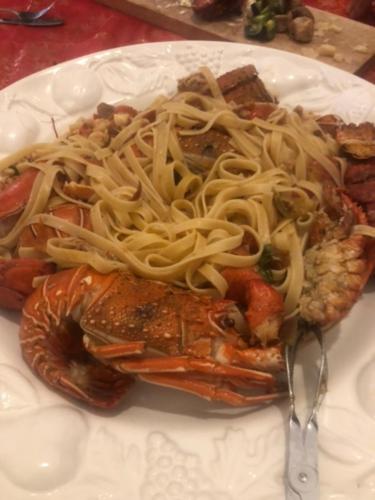 a plate of food with spaghetti on top of meat at Villa Francesca - Manfredi Homes&Villas in Monte SantʼAngelo