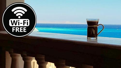 eine Tasse Kaffee auf einem Balkon mit Meerblick in der Unterkunft ELITE VIP - Apartment with sea VIEW - swimming pool - BBQ terrace - near BEACH in Hurghada