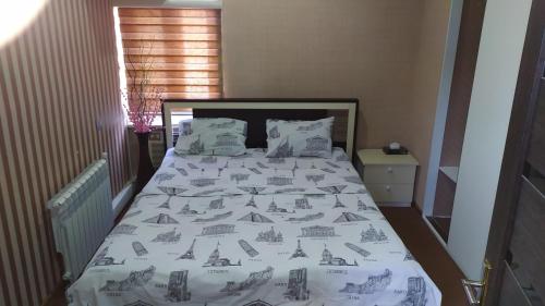 a bedroom with a bed with a white comforter at CTH-Baku-Hostel in Baku