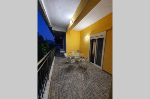 a balcony of a house with a table on it at Villa Fer Forze you have the feeling of your own holiday home in Asprovalta