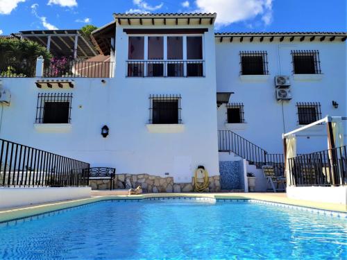 a villa with a swimming pool in front of a building at Villa Sina in Monte Pego